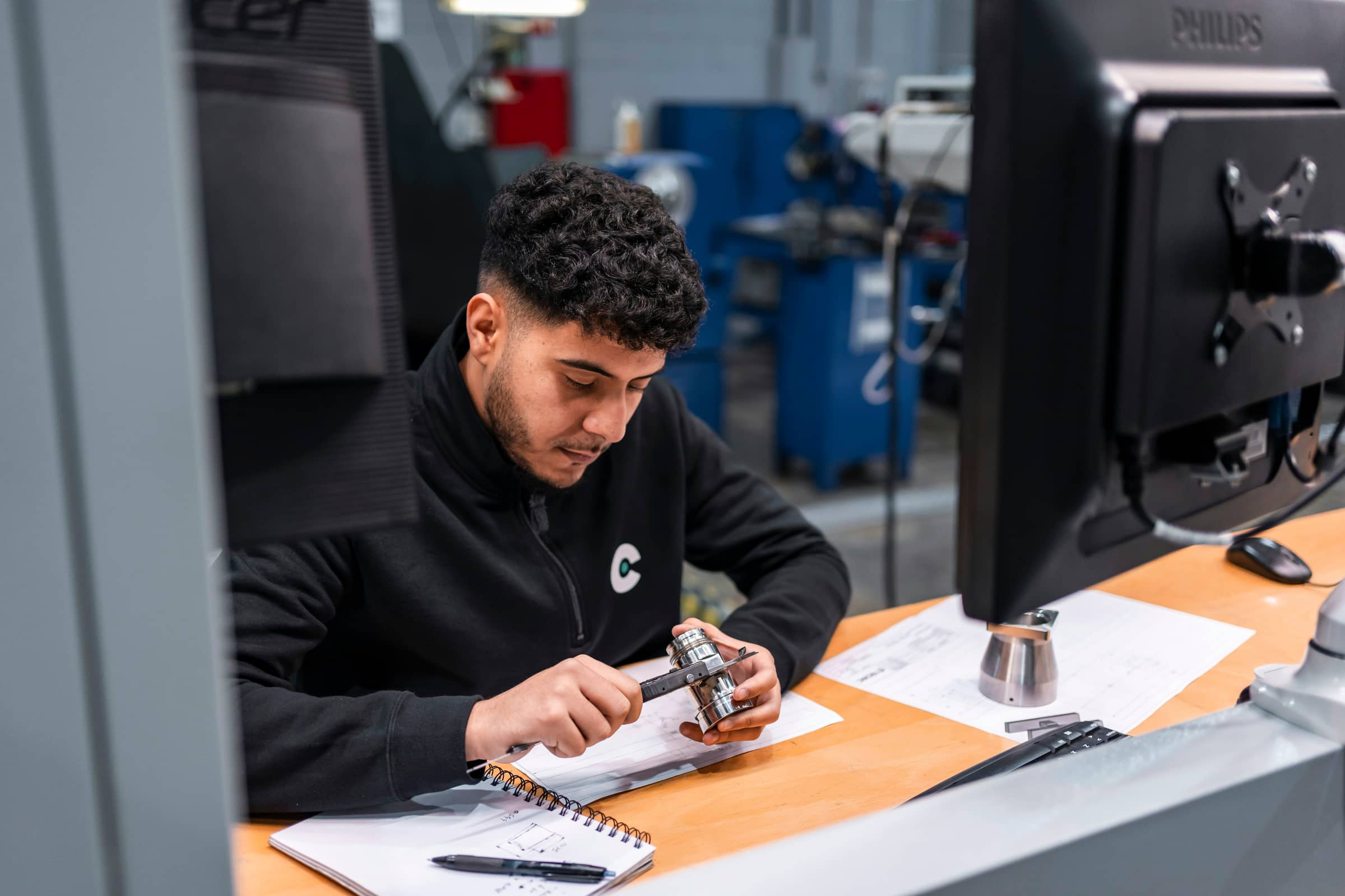 Quality inspector carefully measuring a metal part