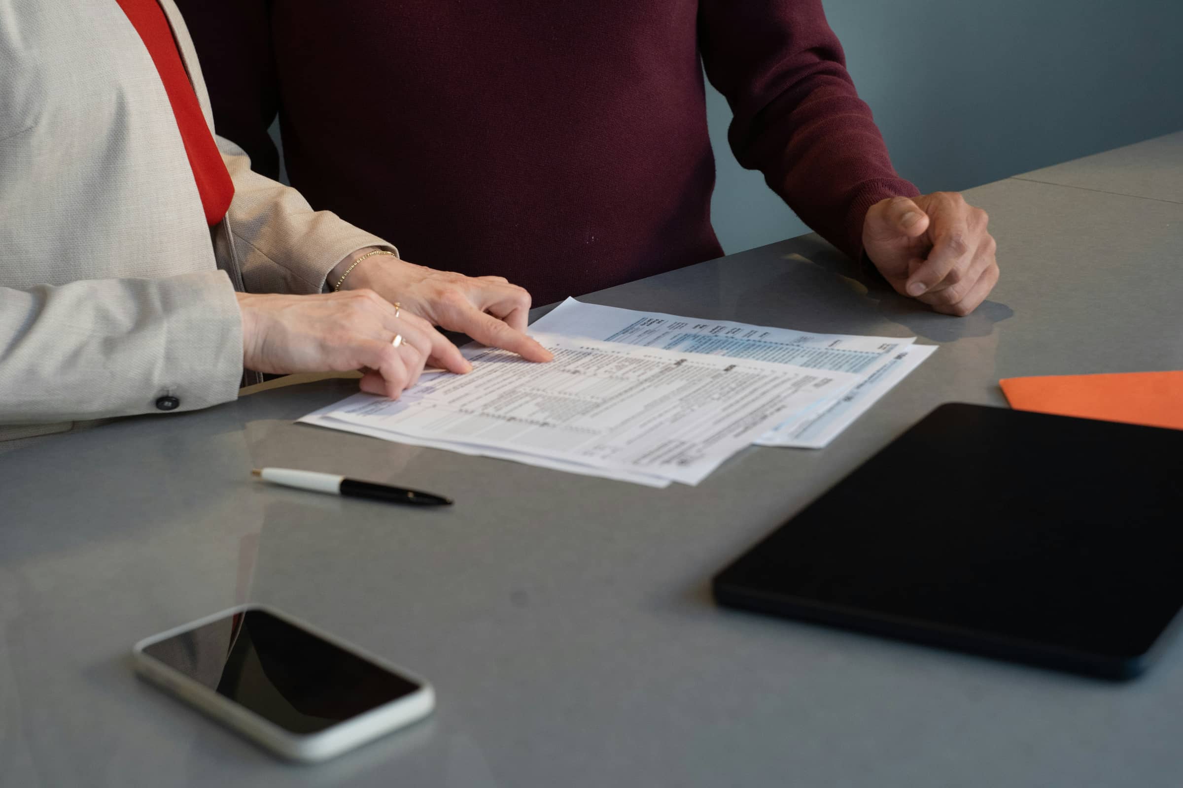 Two people reviewing quote documents at a table